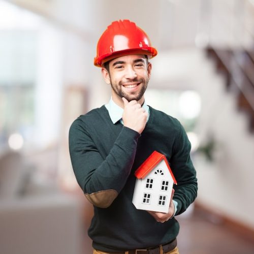 man-with-red-helmet-small-house-hand_1187-1623